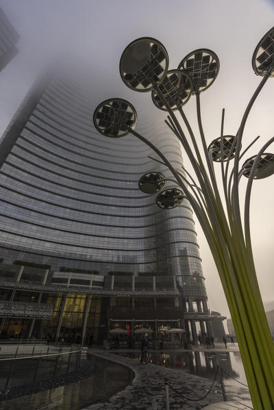 Milan, Lombardy, Italy. Gae Aulenti Square with iconic streetlights. 