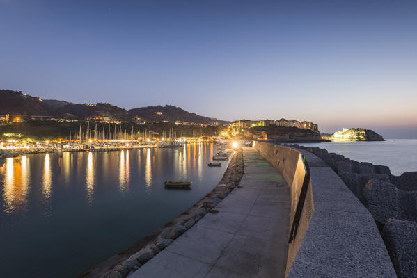 Tropea, Province of Vibo Valentia, Calabria, Italy. Fantastic panoramic view of the Tropea's Harbor during the blue hour with moon