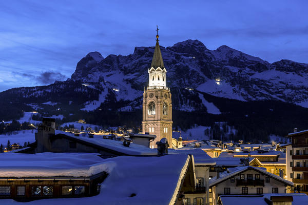 Italy,Veneto,Belluno district,Boite Valley,the bell tower symbol of Cortina d'Ampezzo,with the Tofane group on the background in the evening