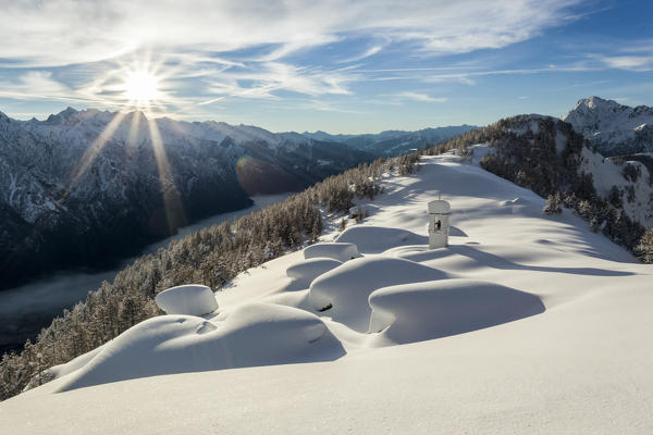 Italy, Italian Alps, Lombardy, The huts and the bell tower of Alpe Cima sorrounded by metres of snow