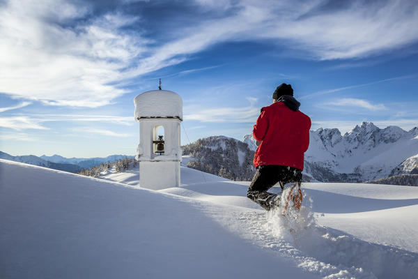 Italy, Italian Alps, Lombardy, The huts and the bell tower of Alpe Cima sorrounded by metres of snow