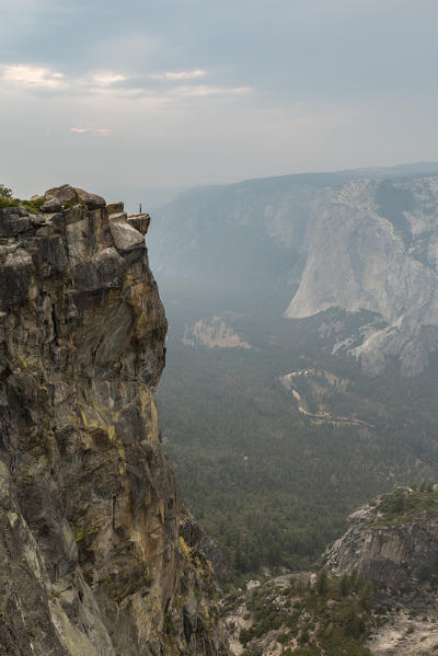 Person on the edge at Taft Point view, Yosemite Valley. Yosemite National Park, Mariposa County, California, USA.