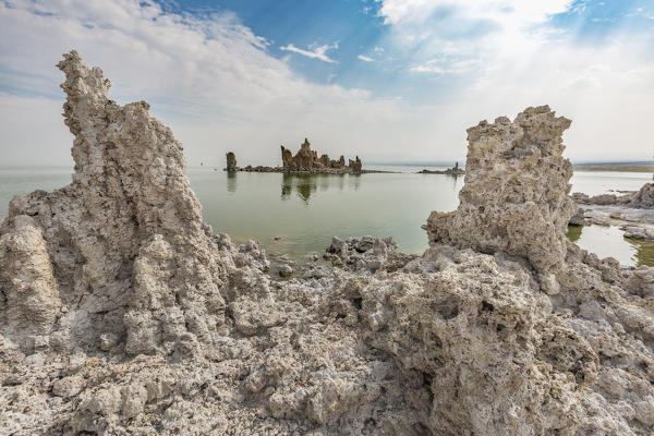 Tufa towers reflect on the waters of Mono Lake. Mono County, California, USA.