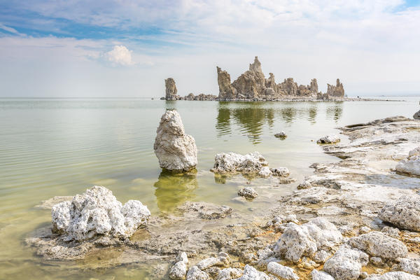 Tufa towers reflect on the waters of Mono Lake. Mono County, California, USA.