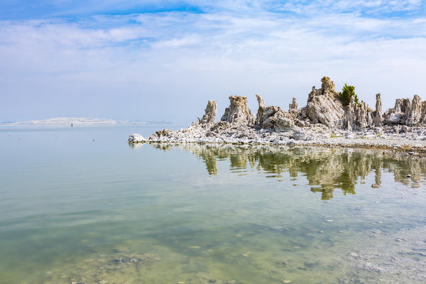 Tufa towers reflect on the waters of Mono Lake. Mono County, California, USA.