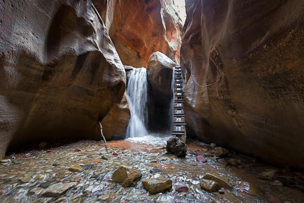 Long exposure at waterfall and ladder in Kanarra Creek Canyon. Kanarraville, Iron County, Utah, USA.