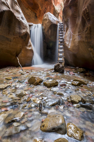 Long exposure at waterfall and ladder in Kanarra Creek Canyon. Kanarraville, Iron County, Utah, USA.