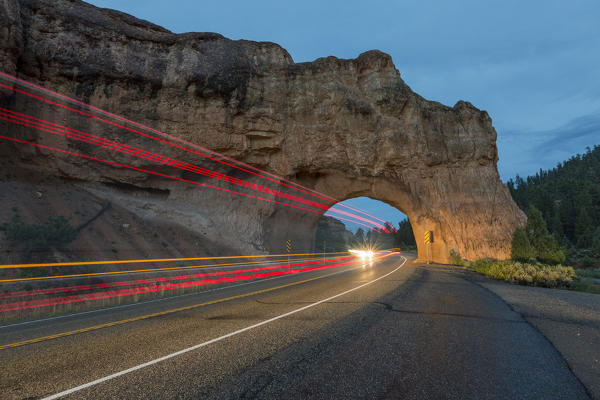 Lights of cars passing through Red Canyon Tunnel on scenic byway 12. Garfield County, Utah, USA: