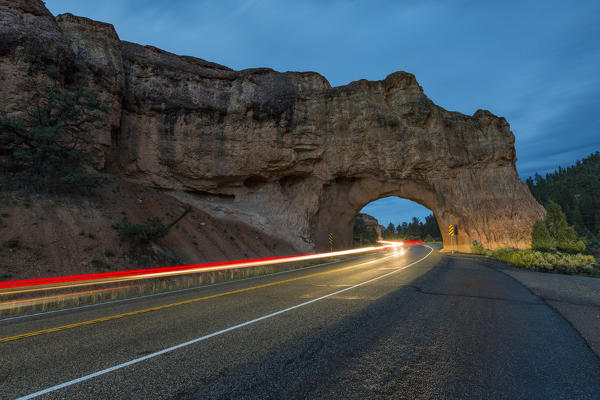 Lights of cars passing through Red Canyon Tunnel on scenic byway 12. Garfield County, Utah, USA: