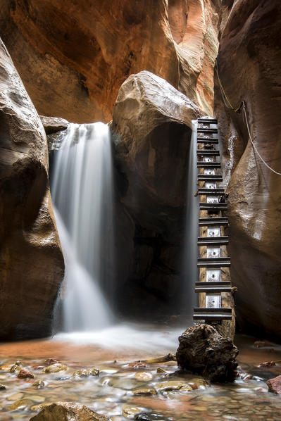 Long exposure at waterfall and ladder in Kanarra Creek Canyon. Kanarraville, Iron County, Utah, USA.