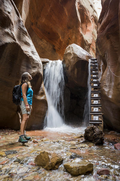 Female hiker at Kanarra Falls. Kanarra Creek Canyon, Kanarraville, Iron County, Utah, USA.