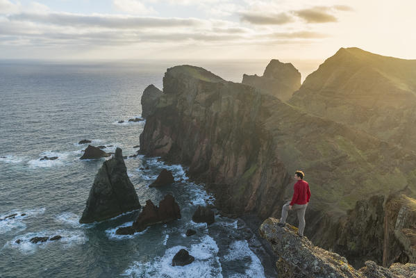 Man admiring the view of  Point of St Lawrence and Furado Point. Canical, Machico district, Madeira region, Portugal.