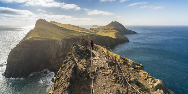 Woman walking on the trail to Point of Saint Lawrence. Canical, Machico district, Madeira region, Portugal.