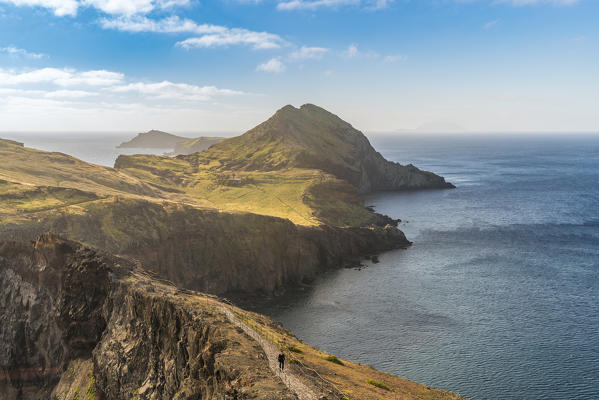 Hiker walking on the trail to Point of Saint Lawrence. Canical, Machico district, Madeira region, Portugal.