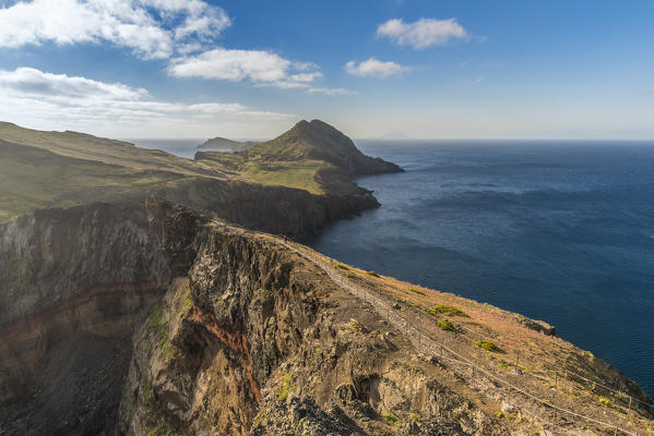 Hiker walking on the trail to Point of Saint Lawrence. Canical, Machico district, Madeira region, Portugal.