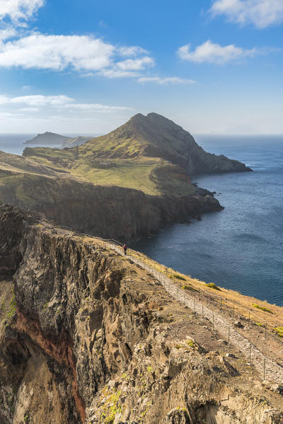 Hiker walking on the trail to Point of Saint Lawrence. Canical, Machico district, Madeira region, Portugal.