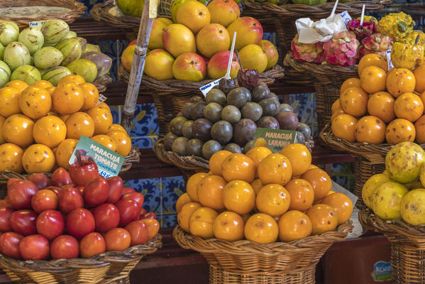 Close up of different varieties of passionfruit and local fruit at Mercado dos Lavradores - Farmers' Market. Funchal, Madeira region, Portugal.