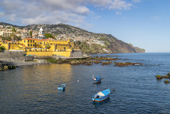 Fishing boats and Sao Tiago fortress. Funchal, Madeira region, Portugal.