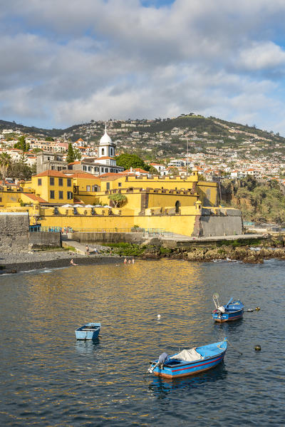 Fishing boats and Sao Tiago fortress. Funchal, Madeira region, Portugal.