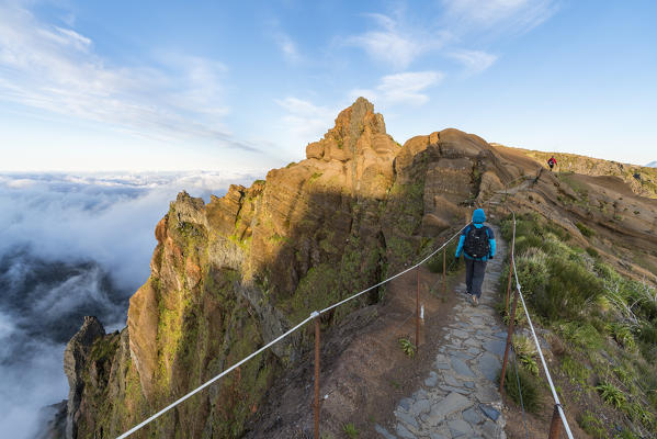 Woman walking on PR1 trail. Pico do Arieiro, Funchal, Madeira region, Portugal.