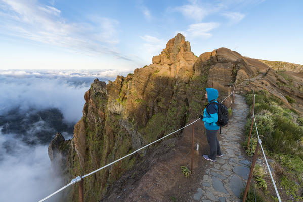 Woman admiring the view from PR1 trail. Pico do Arieiro, Funchal, Madeira region, Portugal.