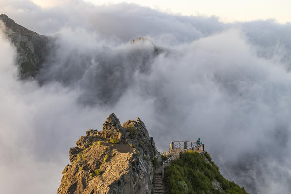 Hiker admiring the view from Ninho da Manta lookout. Pico do Arieiro, Funchal, Madeira region, Portugal.