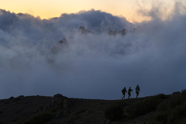 Silhouette of three hikers on Vereda do Areeiro. Pico do Arieiro, Funchal, Madeira region, Portugal.