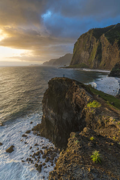 Person on a cliff watching the sunrise. Faial, Santana municipality, Madeira region, Portugal. (MR)