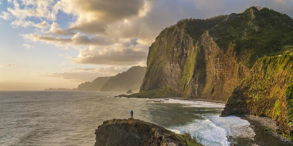 Man taking pictures at dawn. Faial, Santana municipality, Madeira region, Portugal. (MR)