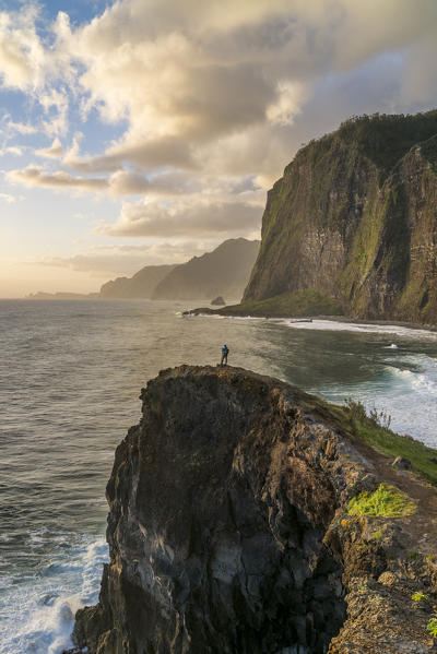 Man taking pictures at dawn. Faial, Santana municipality, Madeira region, Portugal.