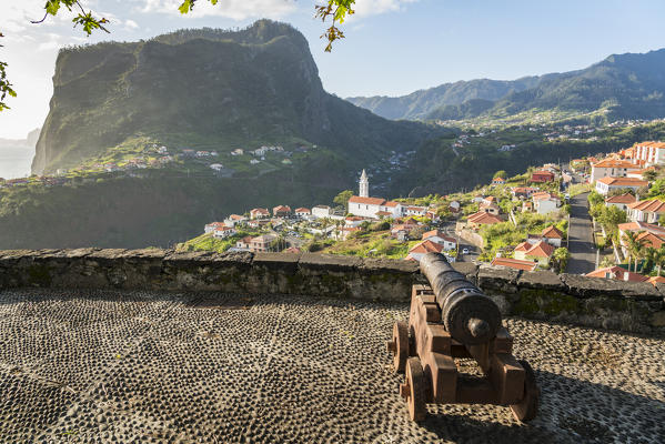 Historical cannon at Faial fortress with the village in the background. Faial, Santana municipality, Madeira region, Portugal.