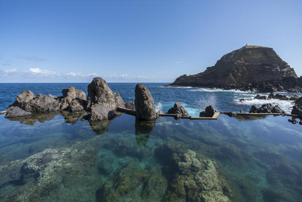 Natural pools with Mole islet in the background. Porto Moniz, Madeira region, Portugal.