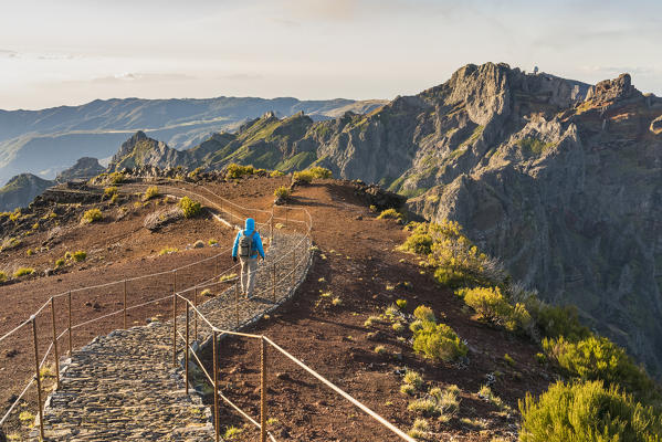 Man walking on Vereda do Pico Ruivo, with Pico do Arieiro in the background. Achada do Teixeira, Santana municipality, Madeira region, Portugal. (MR)