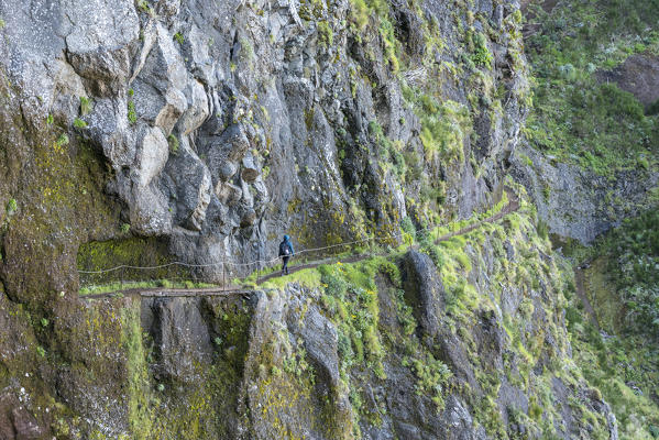 Woman walking on the trail from Pico Ruivo to Pico do Areeiro. Santana municipality, Madeira region, Portugal.