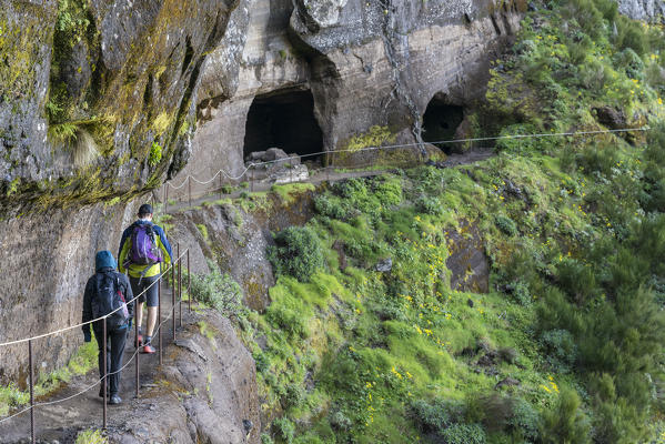 People walking on the trail from Pico Ruivo to Pico do Areeiro. Santana, Madeira region, Portugal.