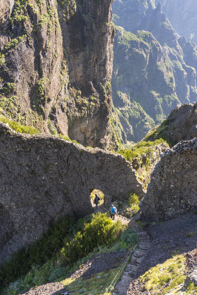 Two people descenging the steps on the trail from Pico Ruivo to Pico do Areeiro. Funchal, Madeira region, Portugal.