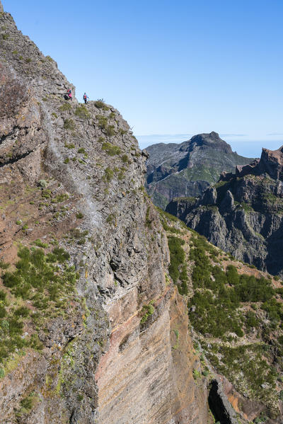 Hikers walking on the trail from Pico Ruivo to Pico do Areeiro. Funchal, Madeira region, Portugal.