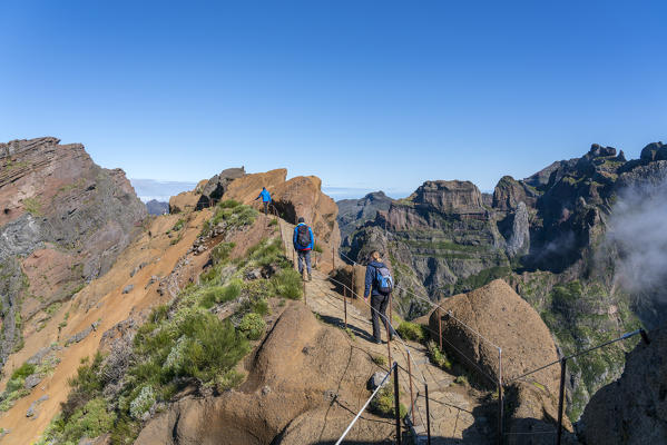 People walking on the trail from Pico Ruivo to Pico do Areeiro. Funchal, Madeira region, Portugal.