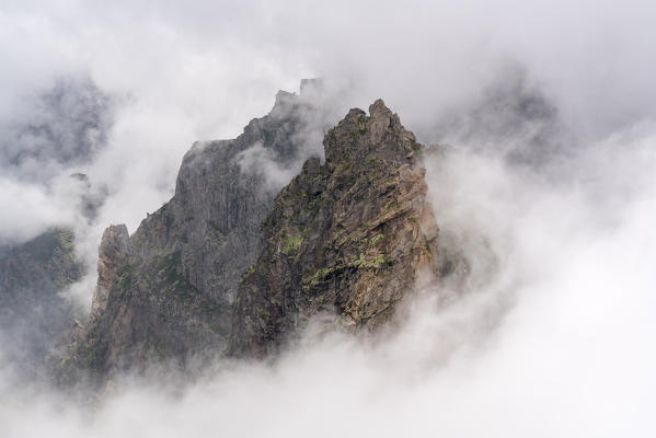 Mountain peaks surrounded by the mist at Pico do Areeiro. Funchal, Madeira region, Portugal.