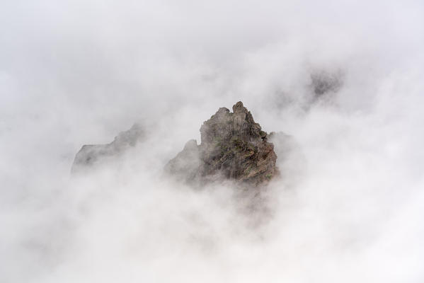 Mountain peaks surrounded by the mist at Pico do Areeiro. Funchal, Madeira region, Portugal.