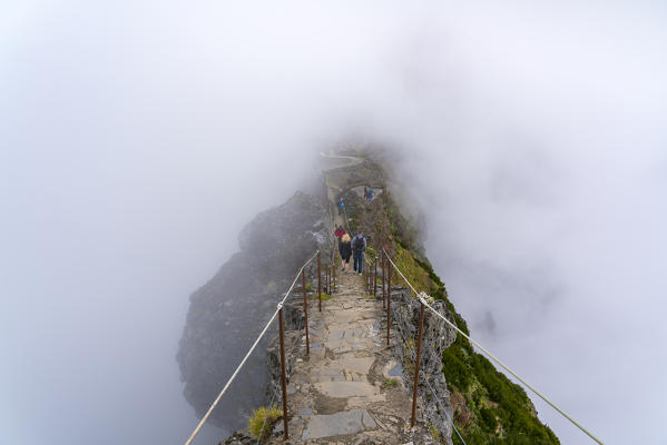 People descending the steps on the trail at Pico do Areeiro. Funchal, Madeira region, Portugal.