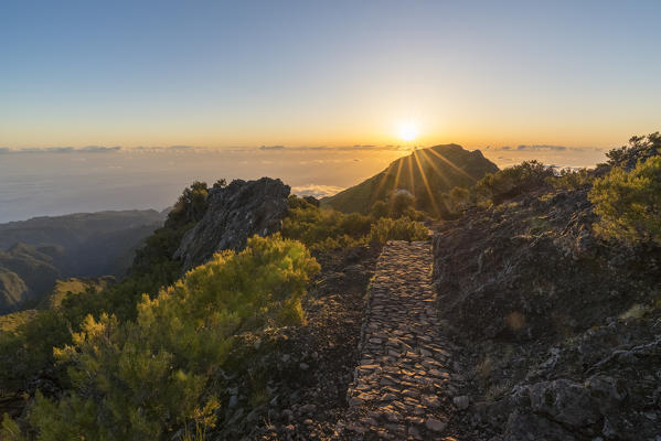 Sunrise over the clouds on the trail to Pico Ruivo. Achada do Teixeira, Santana municipality, Madeira region, Portugal.