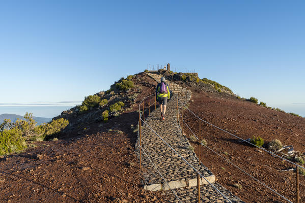 Man walking towards the summit of Pico Ruivo. Achada do Teixeira, Santana municipality, Madeira region, Portugal.