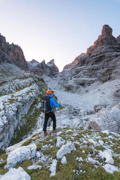 Tuckett refuge between the Brenta dolomites and alpinist at sunrise
Europe, Italy, Trentino, Vallesinella, Tuckett refuge, Brenta dolomites
