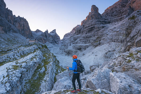 Tuckett refuge between the Brenta dolomites and alpinist at sunrise
Europe, Italy, Trentino, Vallesinella, Tuckett refuge, Brenta dolomites