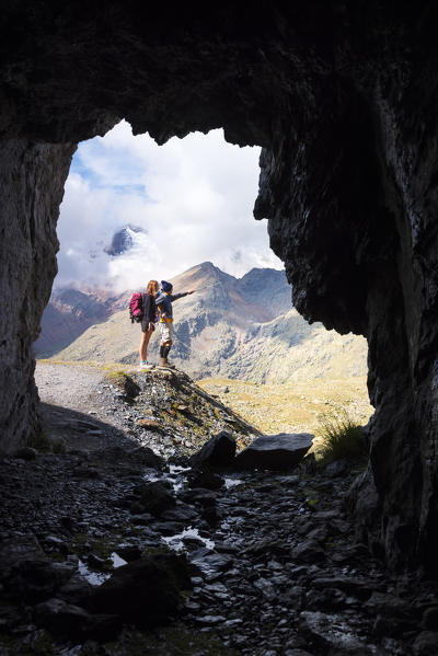 Walkers on the promontory toward Careser Dam
Europe, Italy, Trentino region, Sun valley, Pejo, national park Stelvio