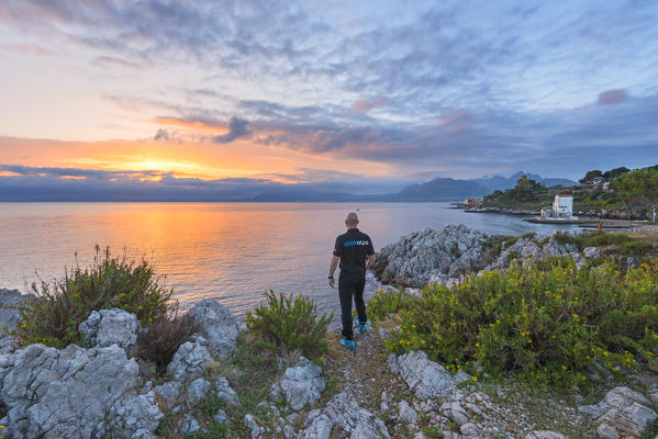 Tourist while admiring the small gulf of Sant'Elia
Europe, Italy, Sicily region, Palermo district, Sant'Elia municipality