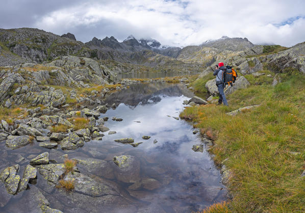 Photographer at work on the reflection on the Rhaetian Alps
Europe, Italy, Trentino, Nambrone valley, Madonna di Campiglio, Sant'Antonio di Mavignola