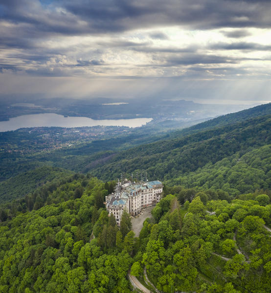 Aerial view of the abandoned Grand Hotel Campo dei Fiori in spring. Campo dei Fiori, Varese, Parco Campo dei Fiori, Lombardy, Italy.