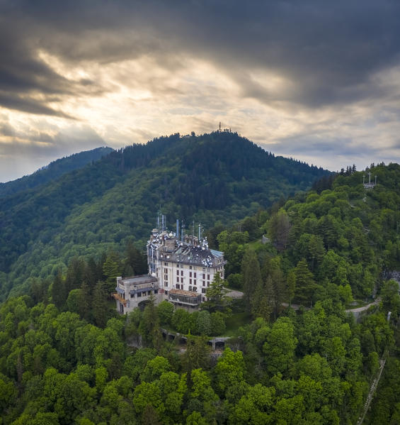 Aerial view of the abandoned Grand Hotel Campo dei Fiori in spring. Campo dei Fiori, Varese, Parco Campo dei Fiori, Lombardy, Italy.